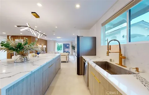 a large kitchen with kitchen island a sink stainless steel appliances and cabinets