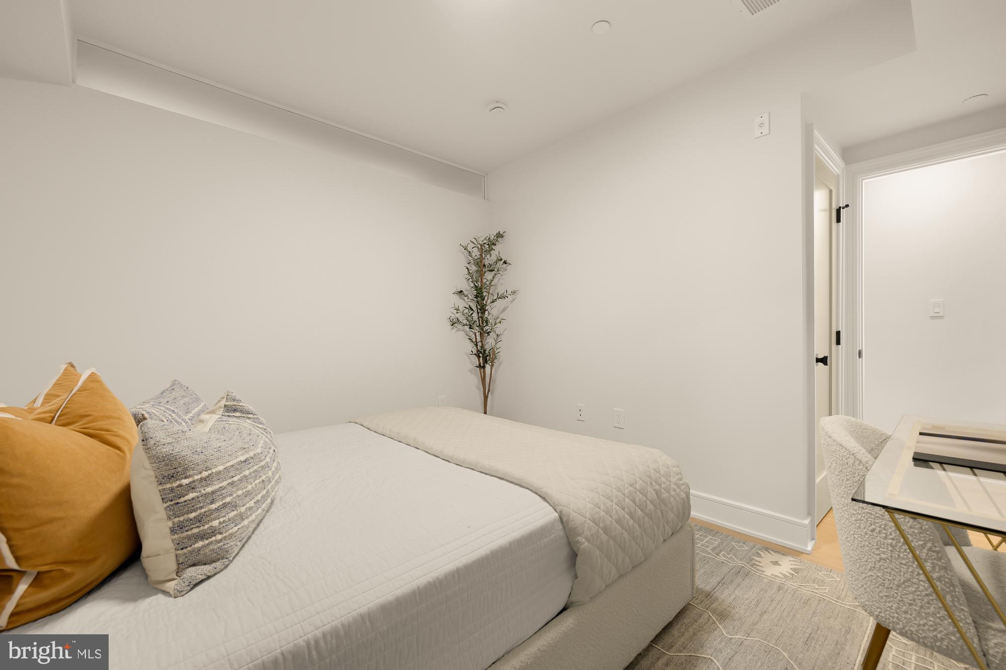 1463 Harvard Street Northwest, Unit 2 Washington, DC 20009 - Photo 14 of 25 a bedroom with a bed and a potted plant