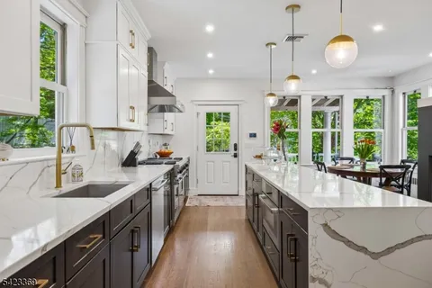 a kitchen with a sink stove and wooden cabinets