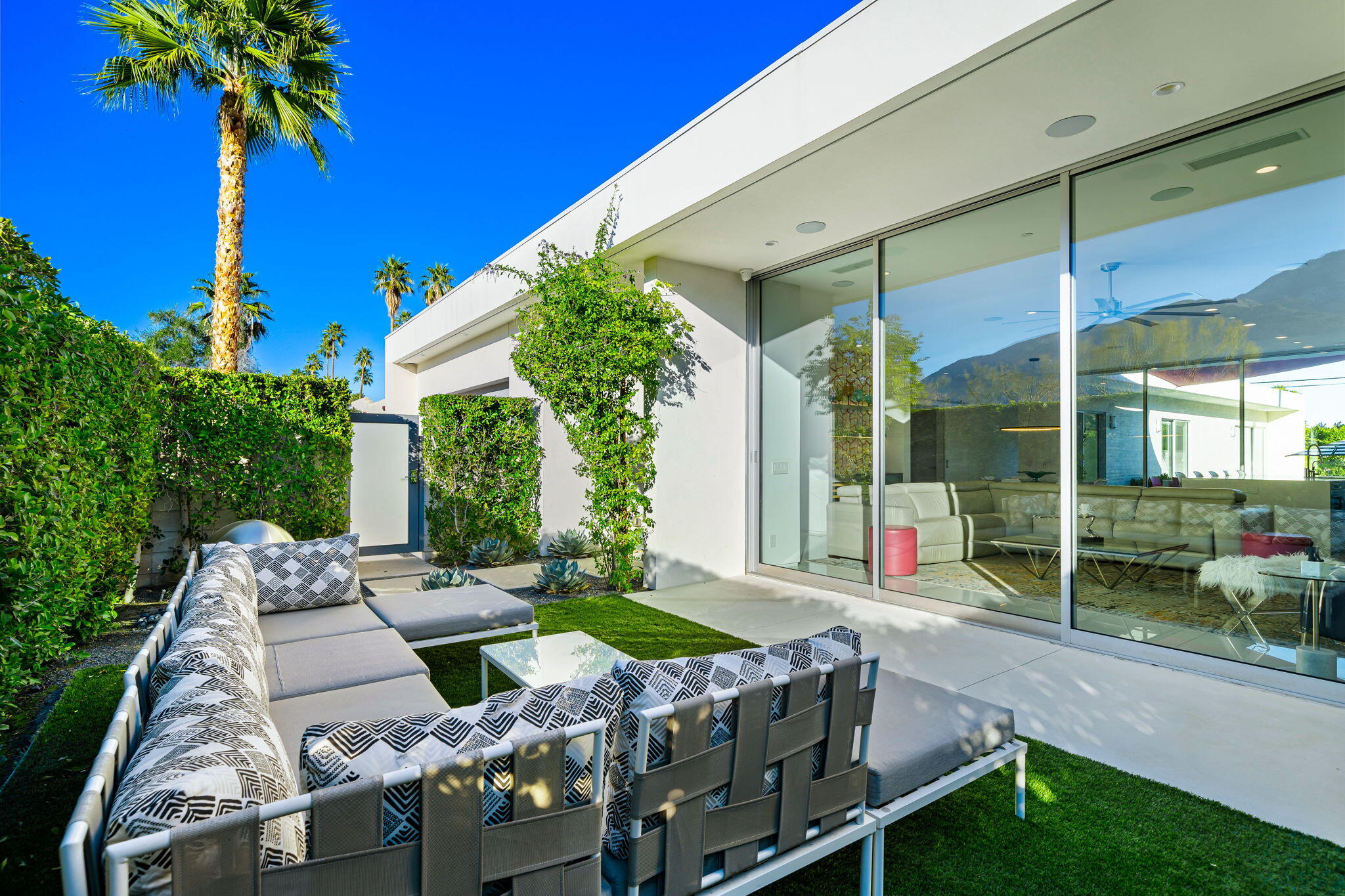 a view of a patio with table and chairs potted plants with wooden floor and fence