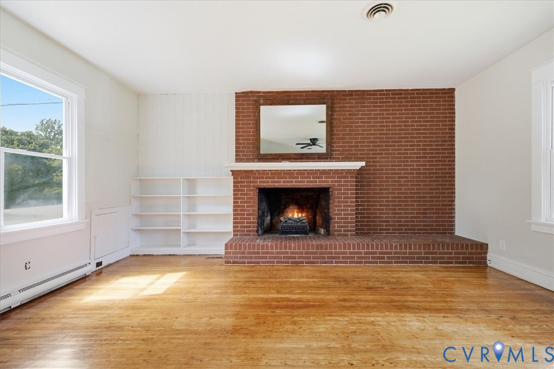 Brick fireplace with a white mantel, wood-finish f