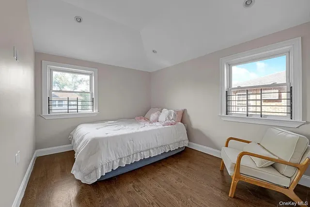 a bedroom with a bed chair and window