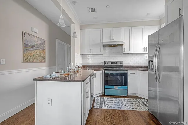 a kitchen with a sink stove and refrigerator