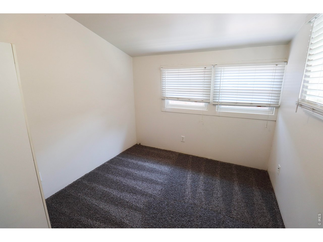 608 South Howes Street Fort Collins, CO 80521 - Photo 18 of 28 a view of an empty room with wooden floor and a window