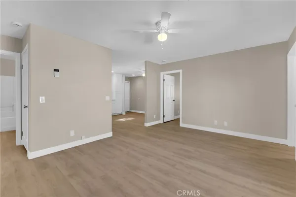 a view of an empty room with a fan
