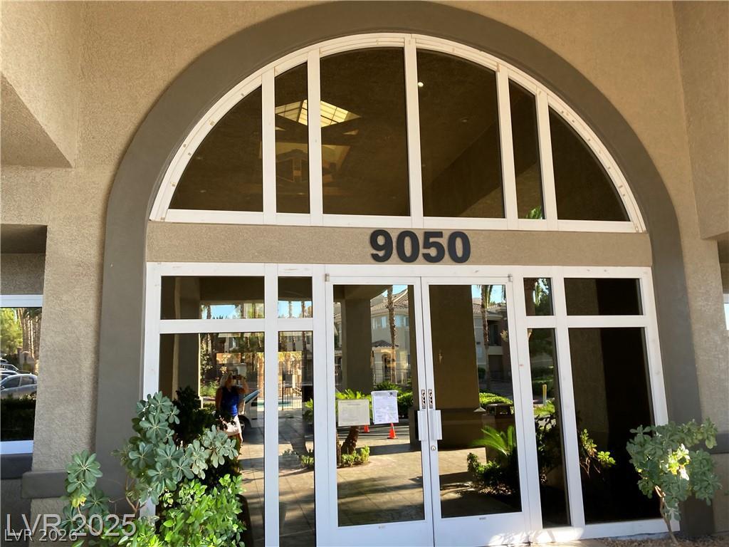 9050 West Warm Springs Road, Unit 1027 Las Vegas, NV 89148 - Photo 31 of 44 An inviting entry archway and glass doors welcome residents into this property.
