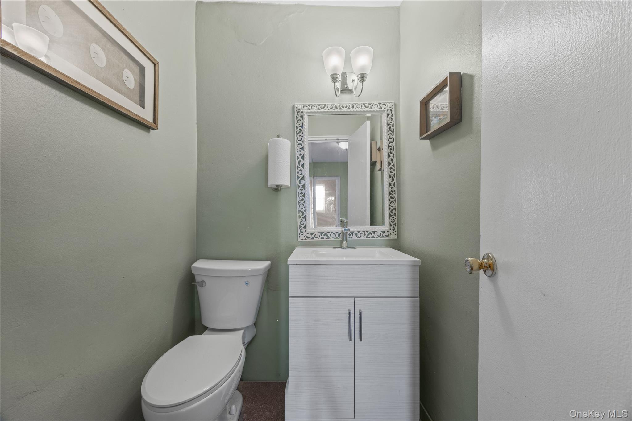 1234 Midland Avenue, Unit 3F Bronxville, NY 10708 - Photo 17 of 23 a bathroom with a toilet a sink and mirror