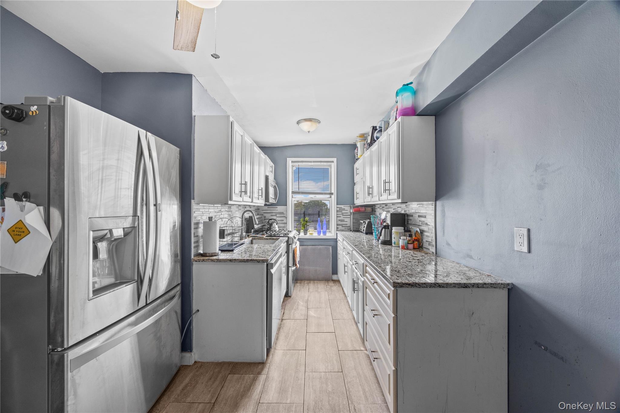 1234 Midland Avenue, Unit 3F Bronxville, NY 10708 - Photo 7 of 23 a kitchen with refrigerator and cabinets