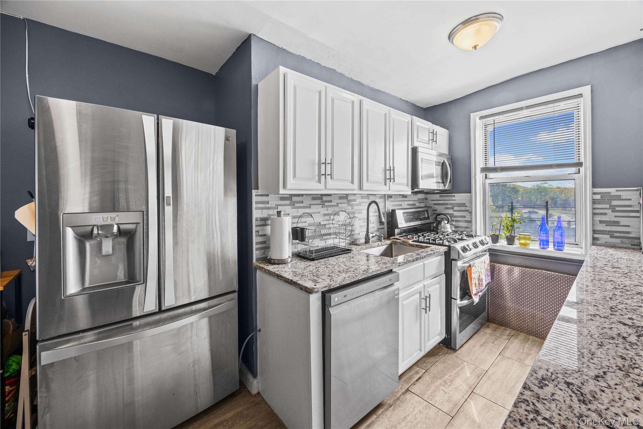 1234 Midland Avenue, Unit 3F Bronxville, NY 10708 - Photo 8 of 23 a kitchen with stainless steel appliances granite countertop a refrigerator sink and stove