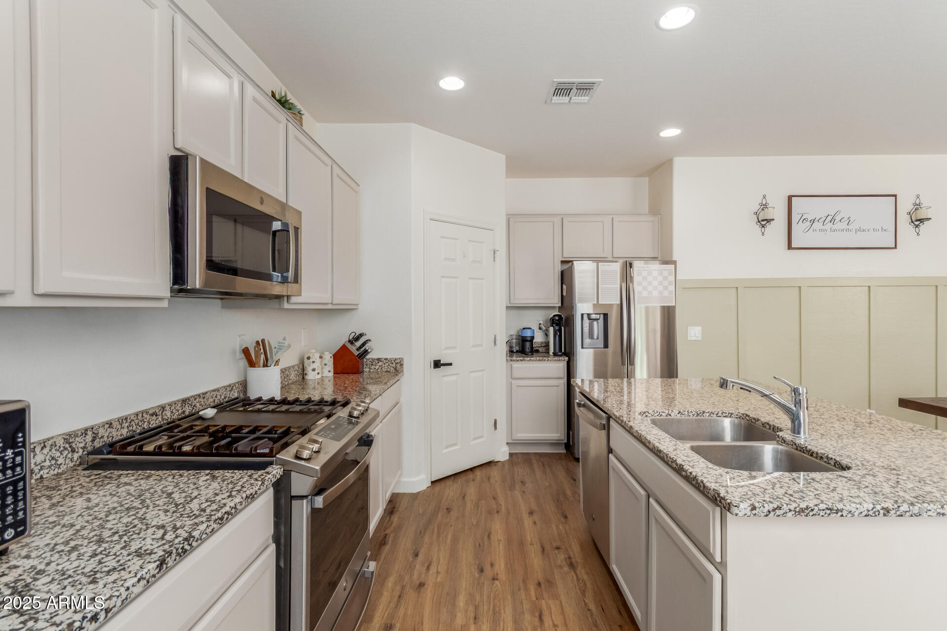 3215 West Pollack Street Phoenix, AZ 85041 - Photo 6 of 26 a kitchen with stainless steel appliances granite countertop a sink stove and refrigerator