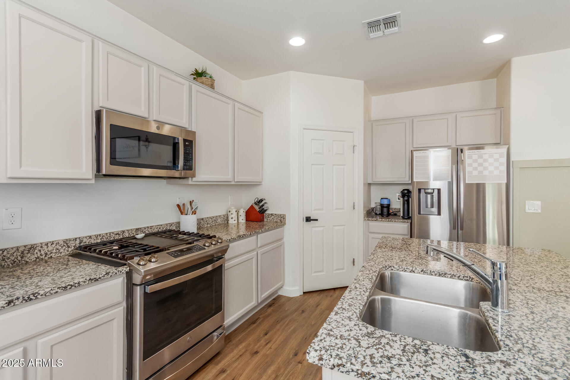 3215 West Pollack Street Phoenix, AZ 85041 - Photo 7 of 26 a kitchen with granite countertop a sink a stove a refrigerator and cabinets