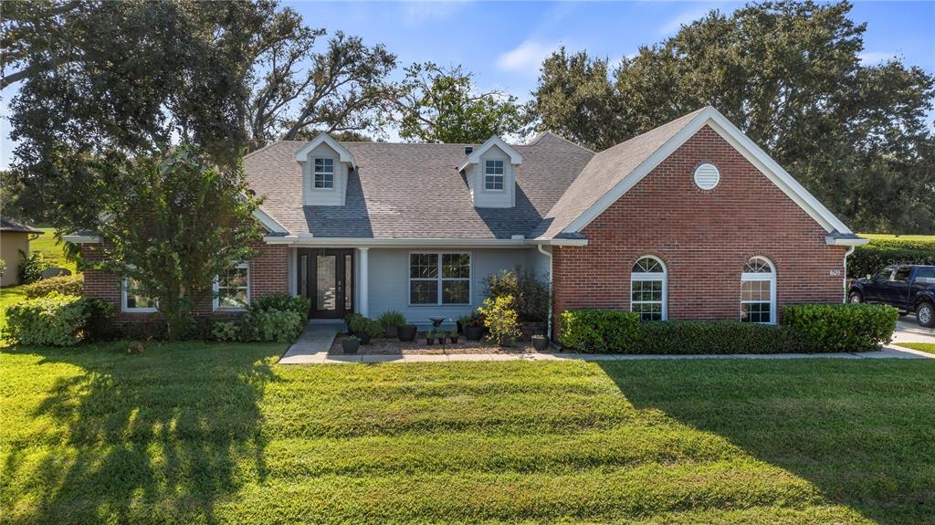 a front view of house with yard and green space
