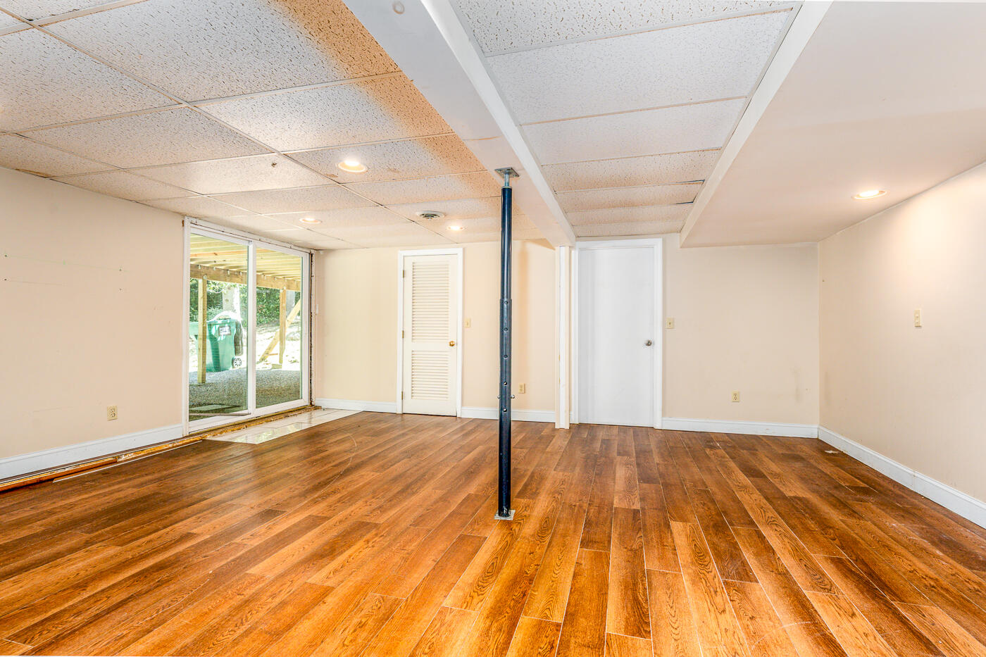 57 Holly Point Road Centerville, MA 02632 - Photo 24 of 41 a view of an empty room with wooden floor and a window