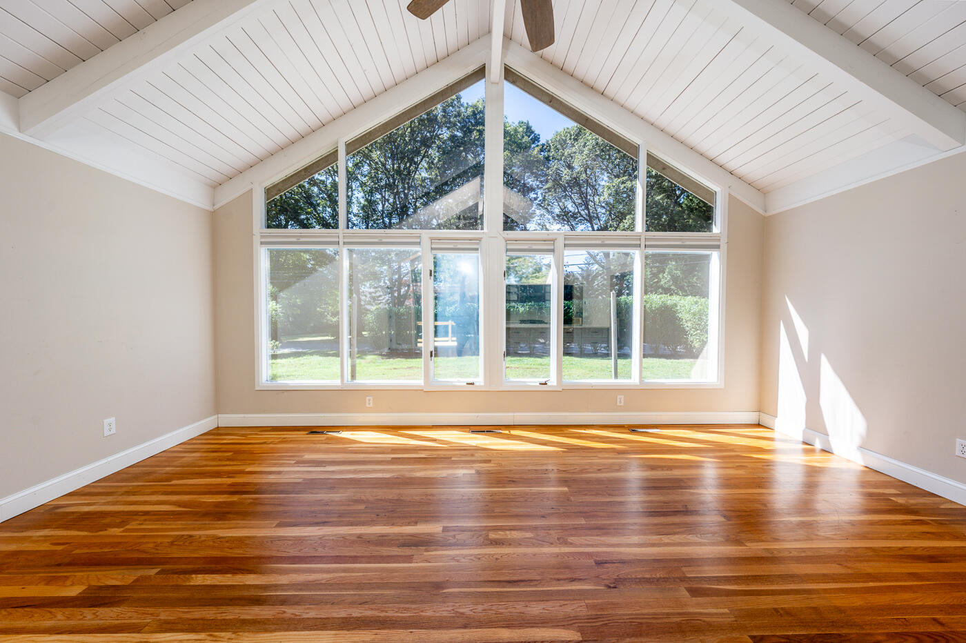 57 Holly Point Road Centerville, MA 02632 - Photo 4 of 41 a view of empty room with wooden floor and windows