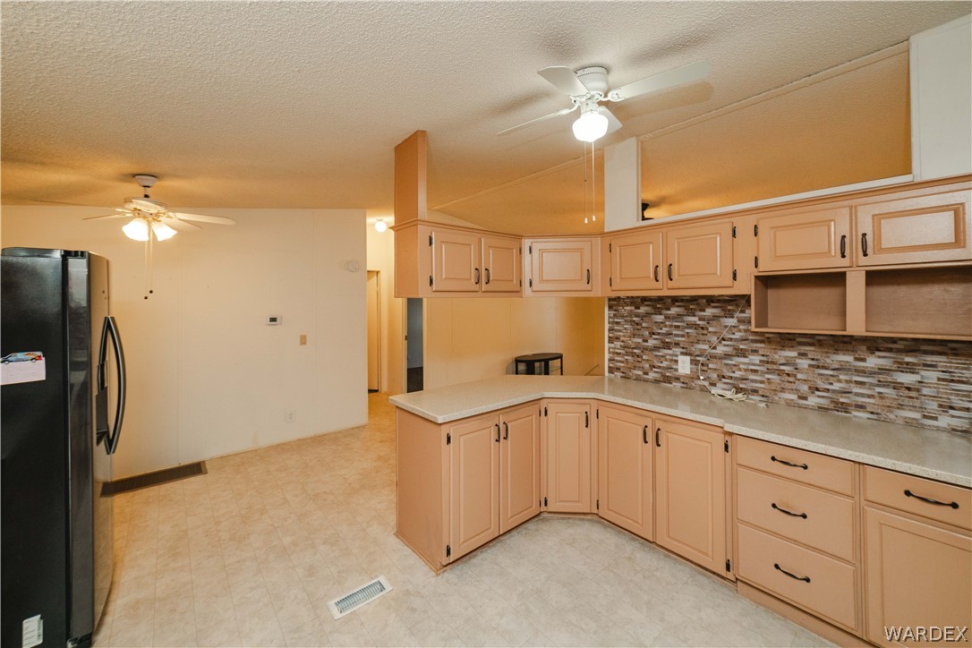 3003 Hualapai Mountain Road Kingman, AZ 86401 - Photo 13 of 49 a kitchen with a sink and refrigerator