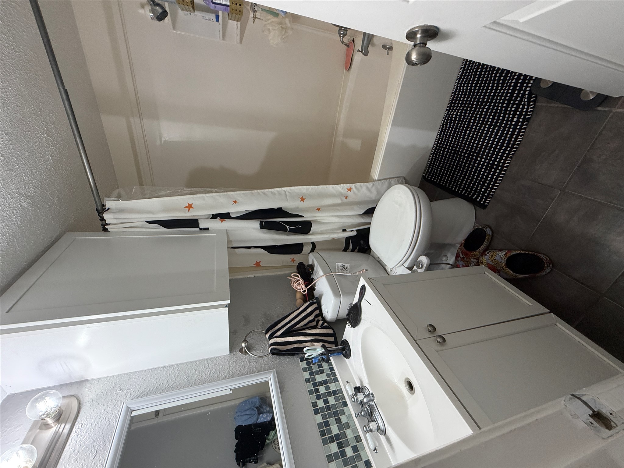 2500 Burleson Road, Unit 611 Austin, TX 78741 - Photo 18 of 22 a bathroom with a sink toilet a mirror and shower