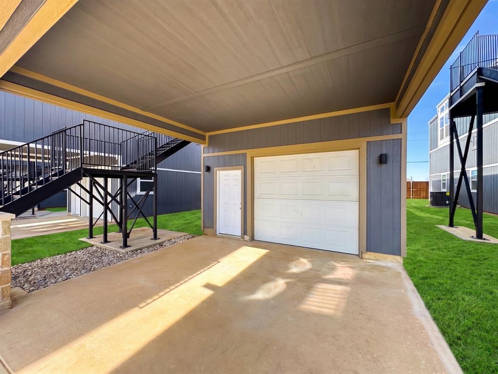 153 Cabrera Street Oak Point, TX 75068 - Photo 13 of 22 Covered parking area featuring a white panel garage door and a side entry door