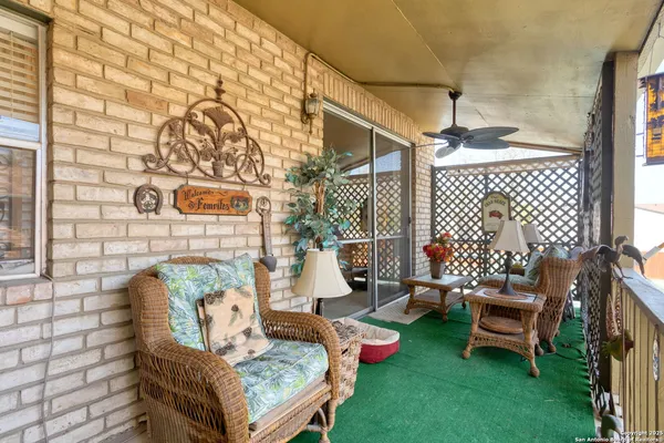 a view of a chairs and table in patio with potted plants