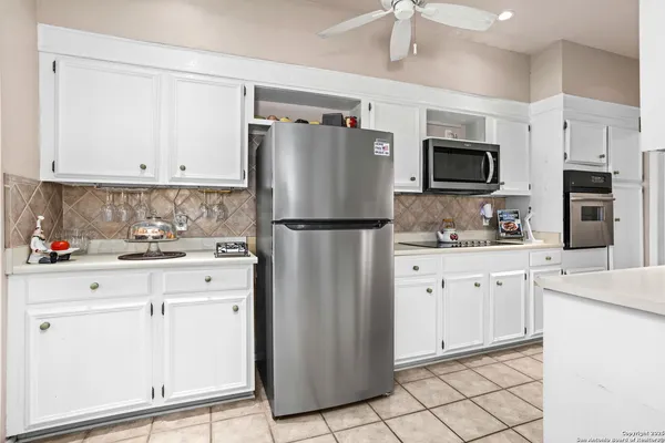 a kitchen with a stove a refrigerator and a sink