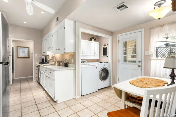 a kitchen with cabinets and window