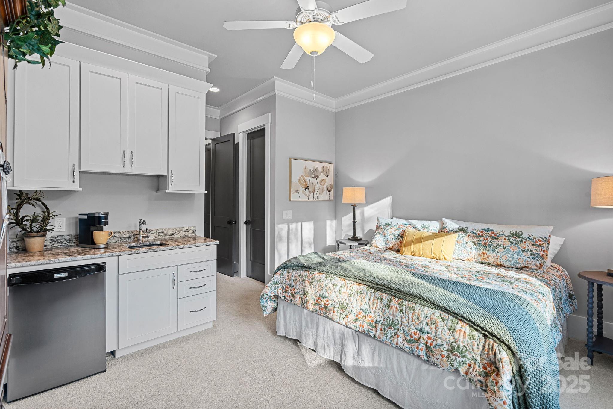 327 Kenway Loop Mooresville, NC 28117 - Photo 20 of 46 a bedroom with a bed and a chandelier