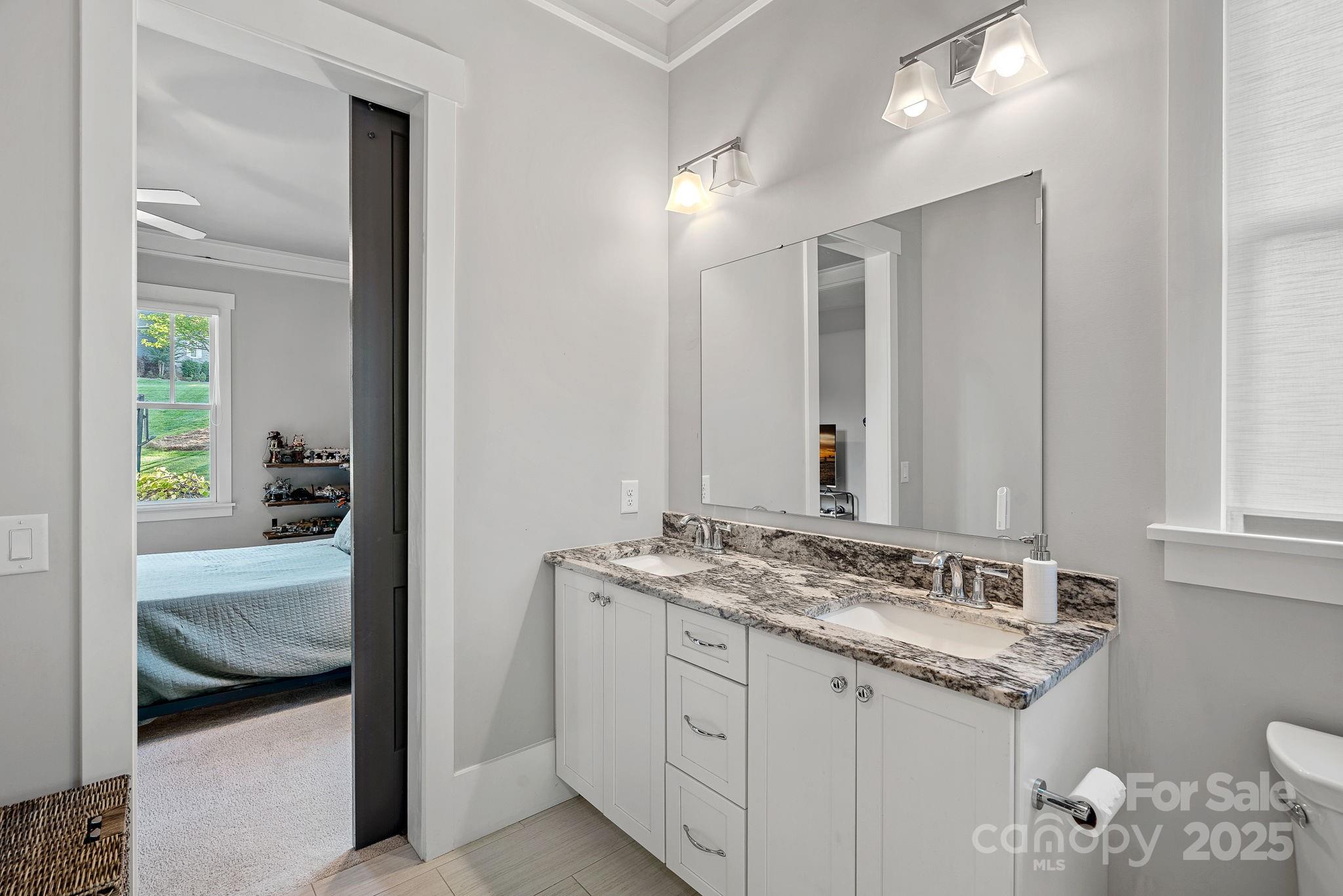 327 Kenway Loop Mooresville, NC 28117 - Photo 23 of 46 a en suite bathroom with a granite countertop sink and a mirror