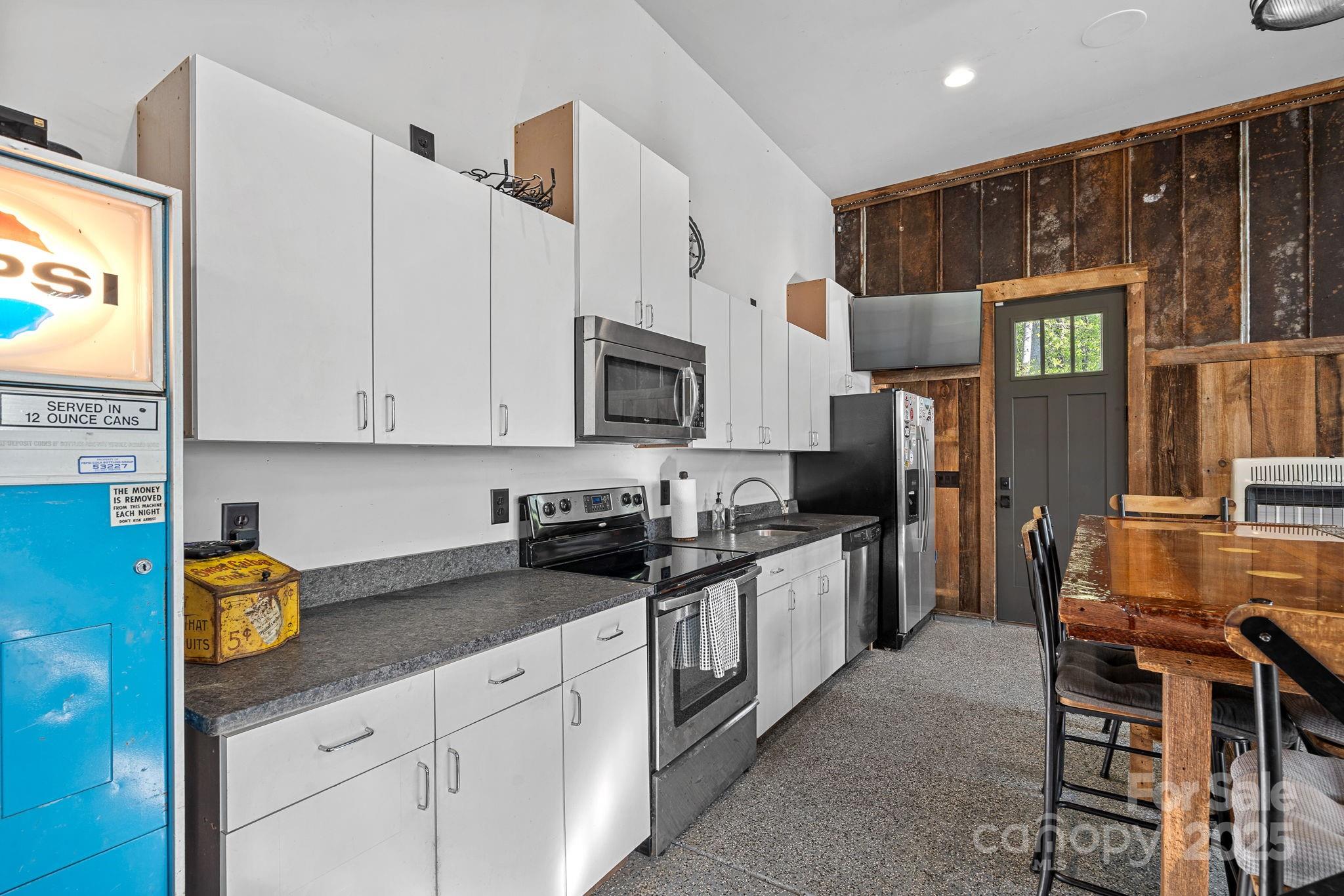 327 Kenway Loop Mooresville, NC 28117 - Photo 35 of 46 a kitchen with granite countertop a sink stove and cabinets
