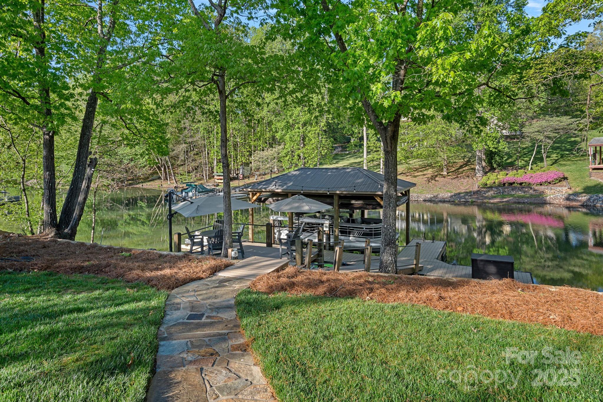 327 Kenway Loop Mooresville, NC 28117 - Photo 45 of 46 a view of patio with table and chairs under an umbrella