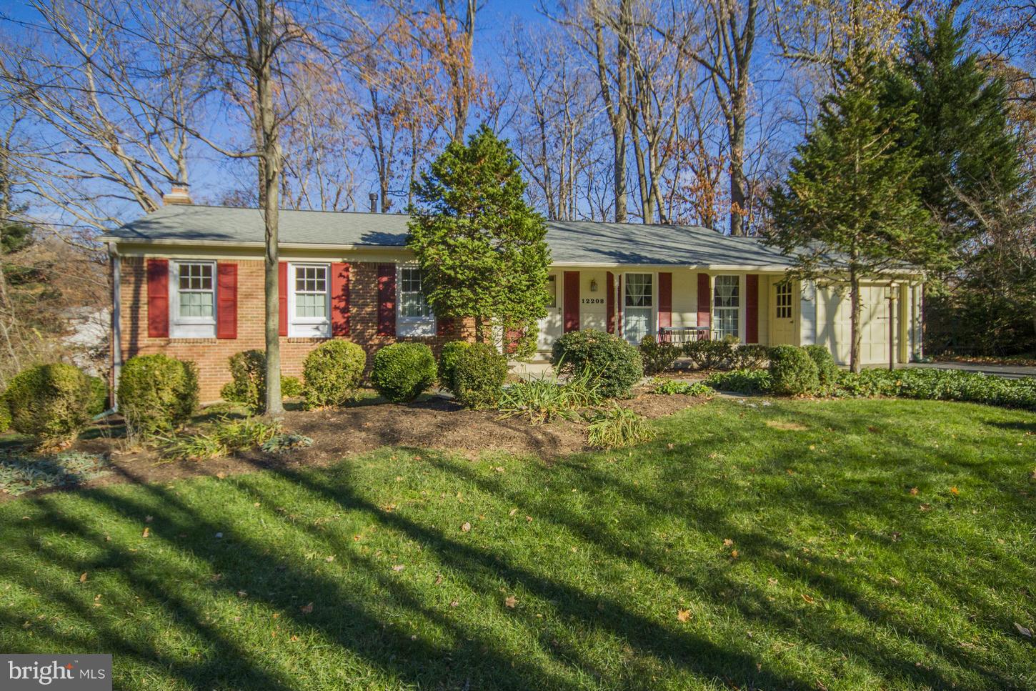12208 St James Road Potomac, MD 20854 - Photo 2 of 29 front view of a house with a garden
