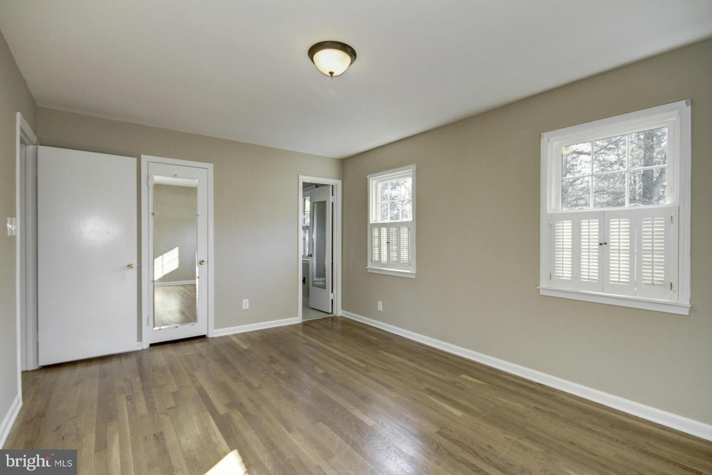 12208 St James Road Potomac, MD 20854 - Photo 13 of 29 a view of an empty room with wooden floor and a window