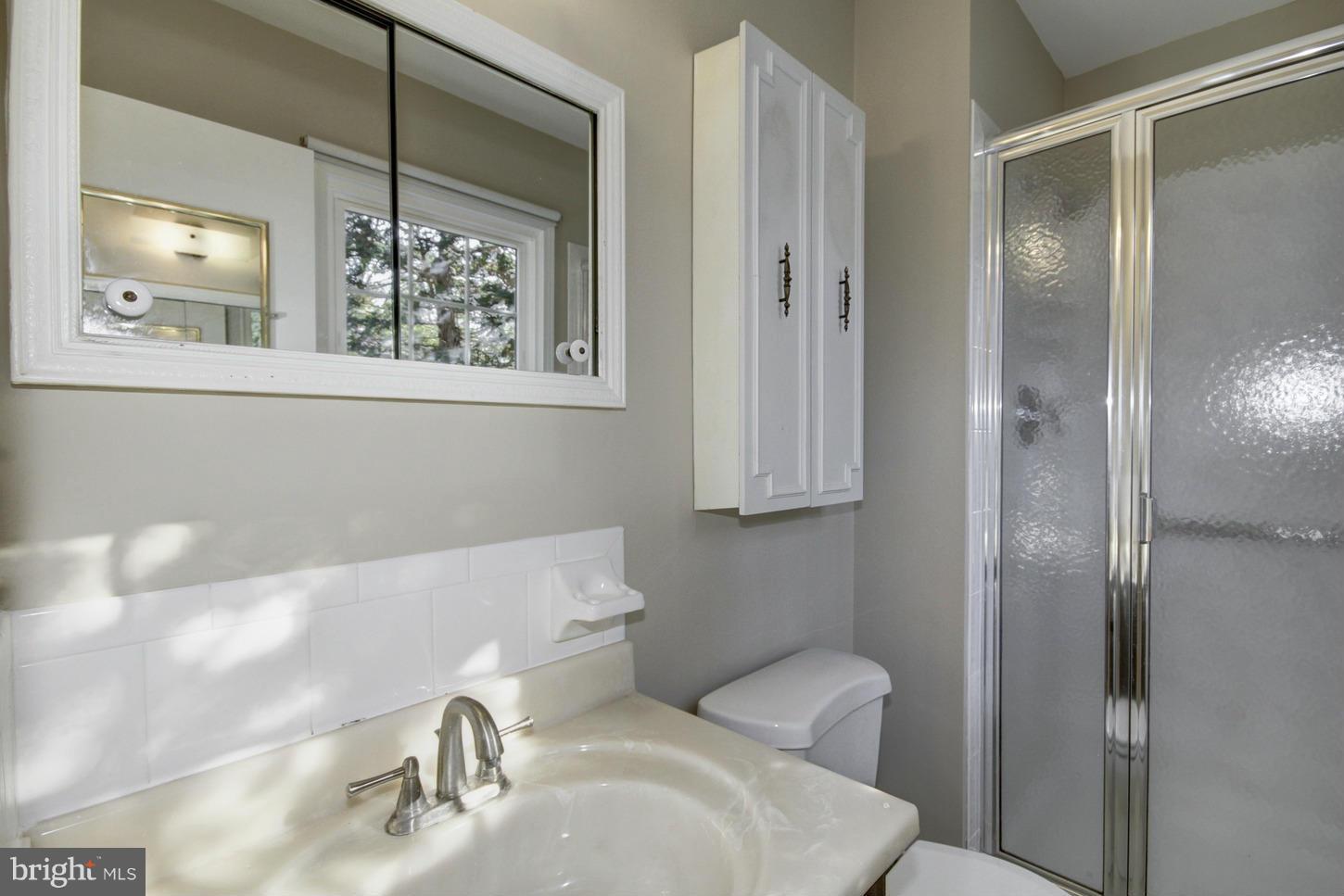 12208 St James Road Potomac, MD 20854 - Photo 14 of 29 a bathroom with a toilet sink and shower