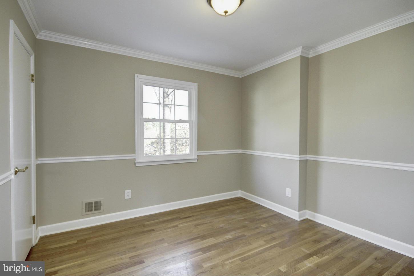 12208 St James Road Potomac, MD 20854 - Photo 15 of 29 an empty room with wooden floor and windows