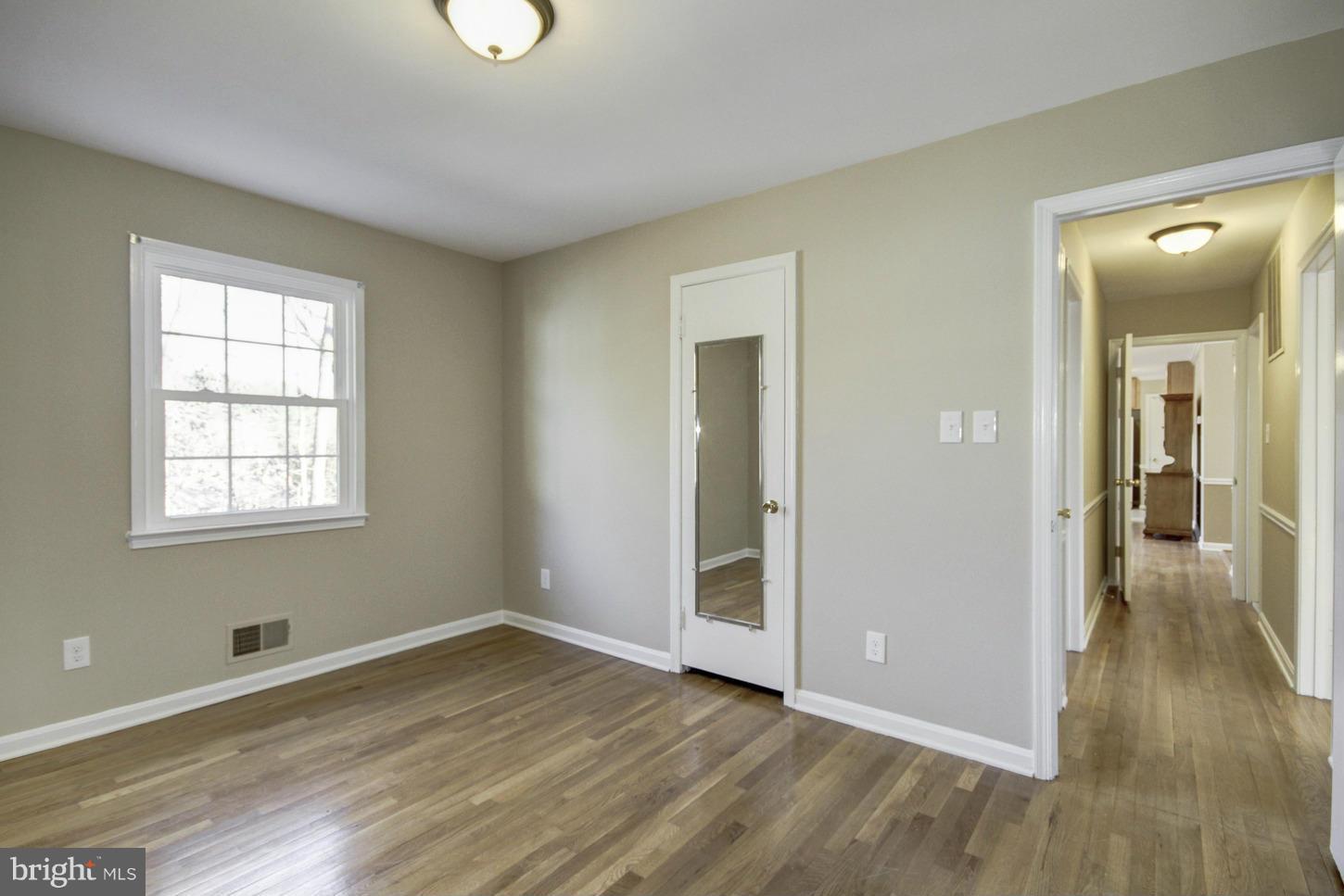 12208 St James Road Potomac, MD 20854 - Photo 17 of 29 wooden floor in an empty room with a window