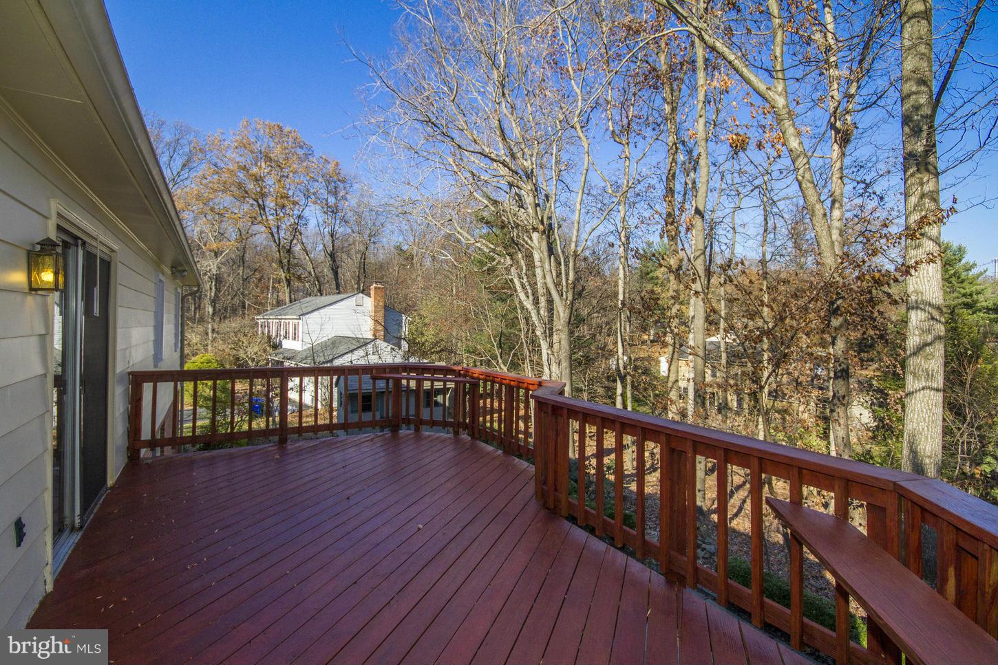 12208 St James Road Potomac, MD 20854 - Photo 26 of 29 a balcony with wooden floor and trees