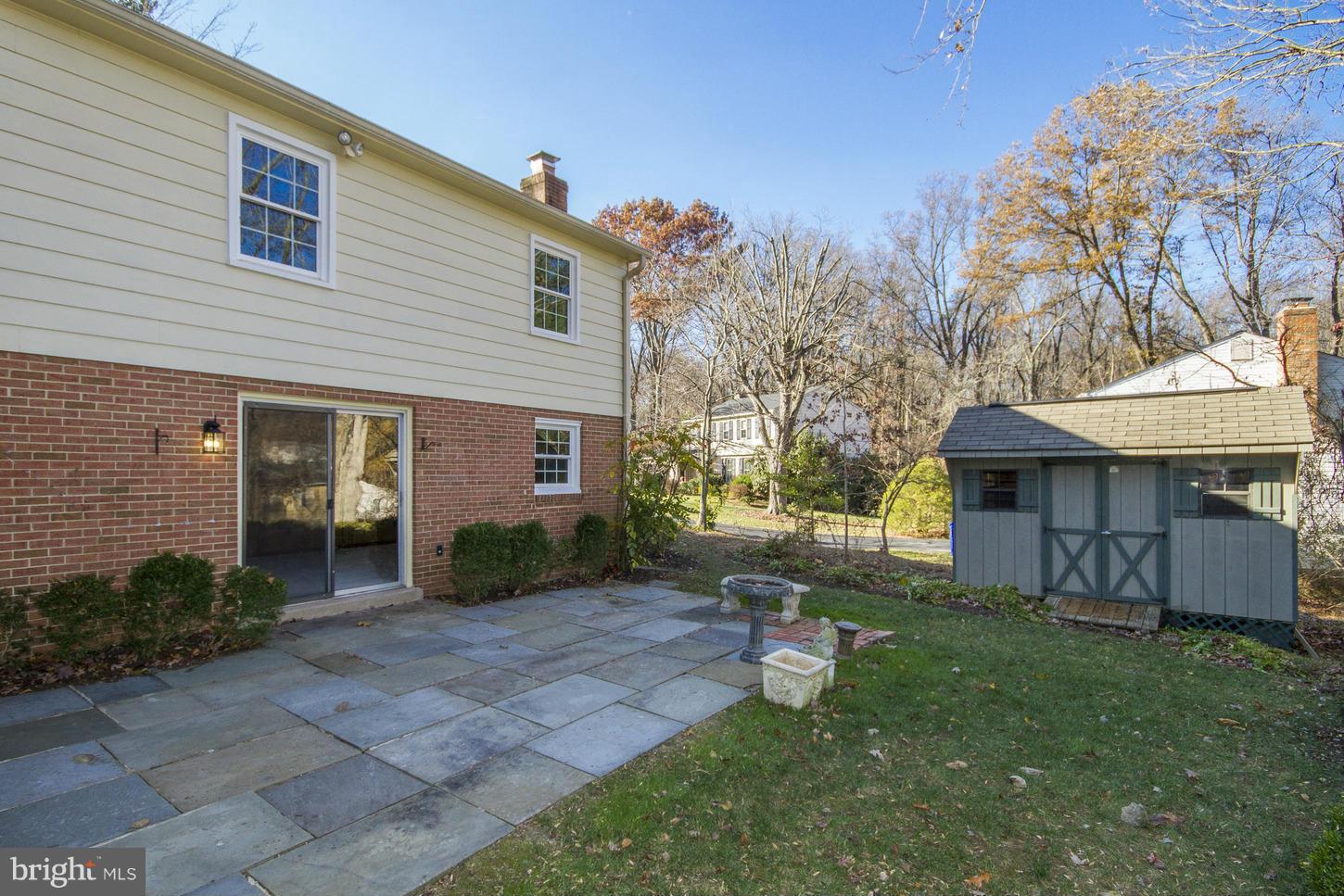 12208 St James Road Potomac, MD 20854 - Photo 28 of 29 a view of a house with backyard and a tree
