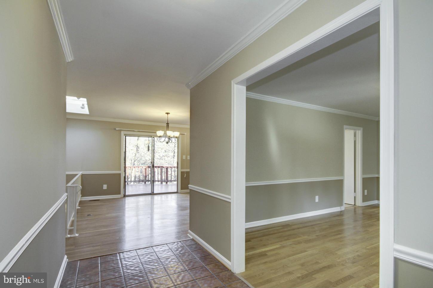 12208 St James Road Potomac, MD 20854 - Photo 4 of 29 a view of a hallway with wooden floor and a bathroom