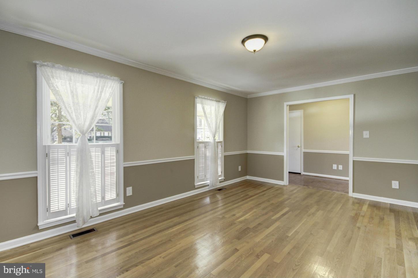 12208 St James Road Potomac, MD 20854 - Photo 5 of 29 an empty room with wooden floor and windows