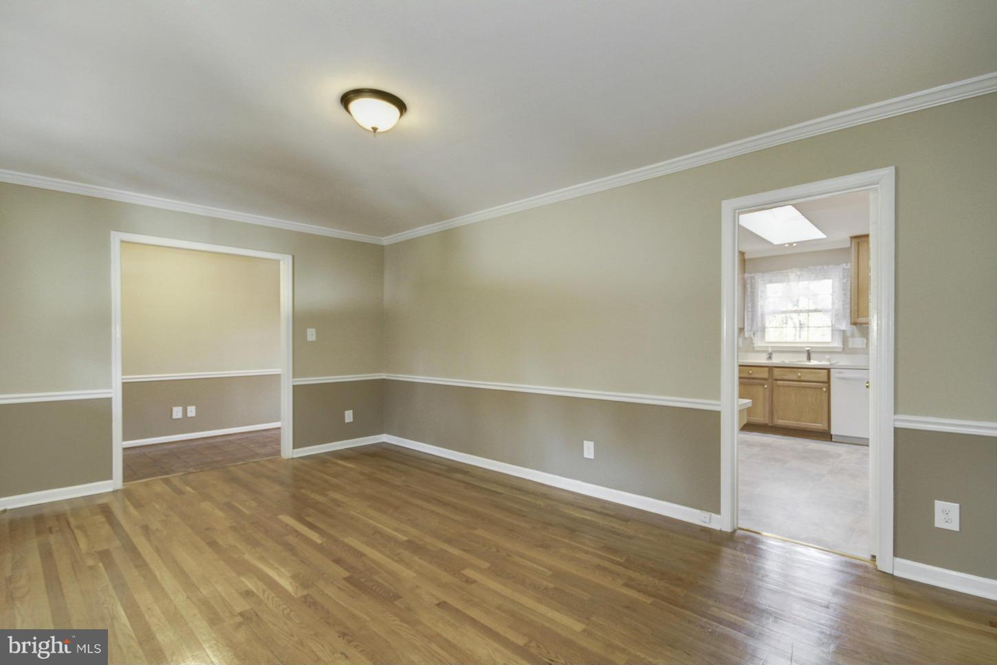 12208 St James Road Potomac, MD 20854 - Photo 6 of 29 an empty room with wooden floor and windows