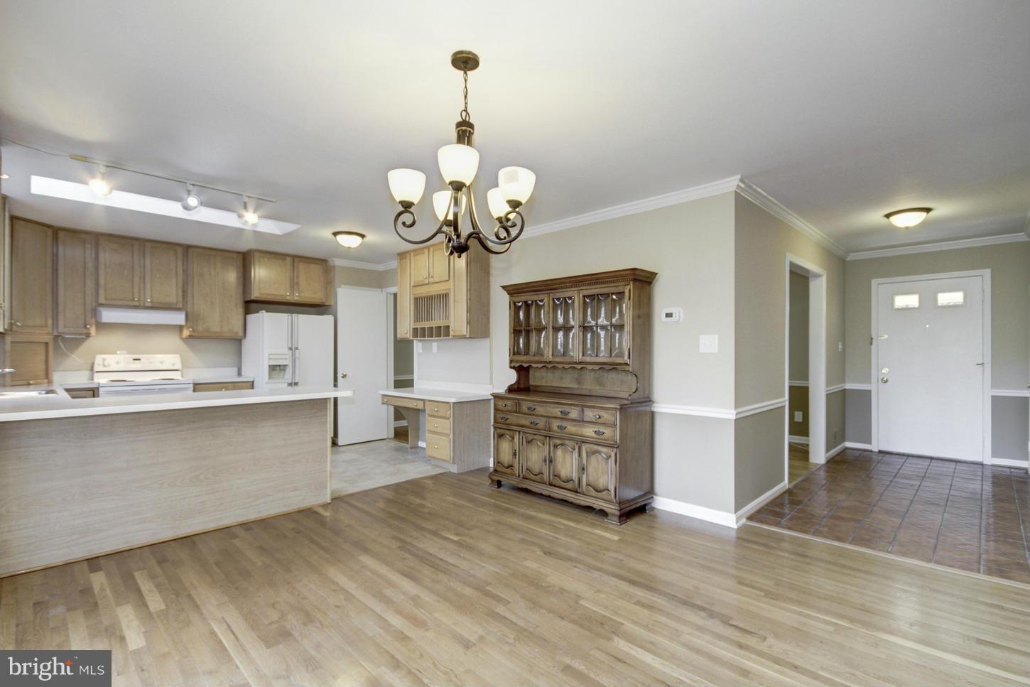 12208 St James Road Potomac, MD 20854 - Photo 9 of 29 a view of a kitchen center island wooden floor and living room view