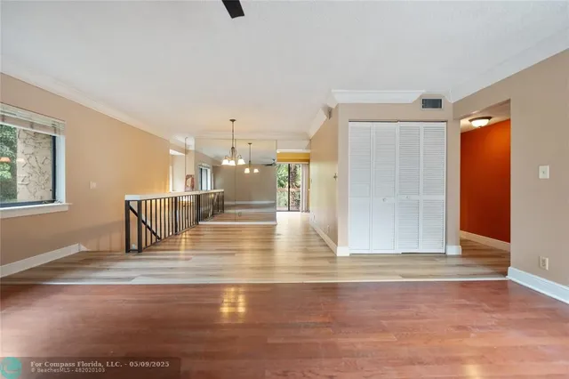 a view of a living room with kitchen island furniture and a floor to ceiling window