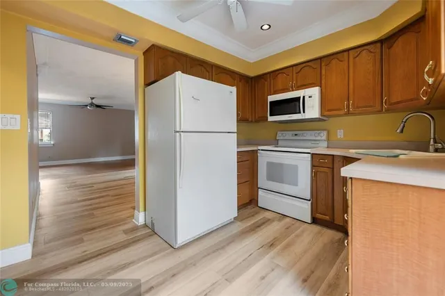 a kitchen with a sink stainless steel appliances and cabinets