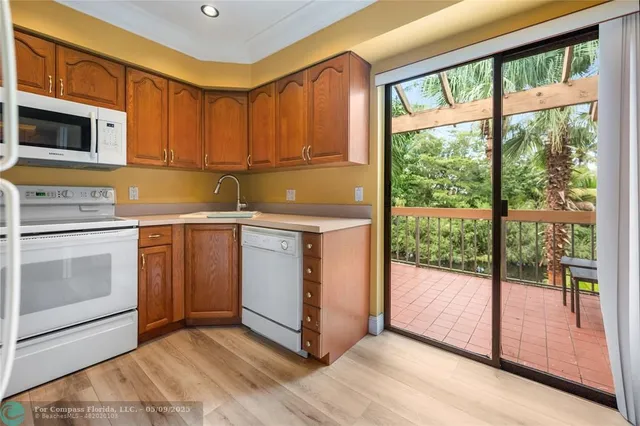 a kitchen with a stove sink and cabinets