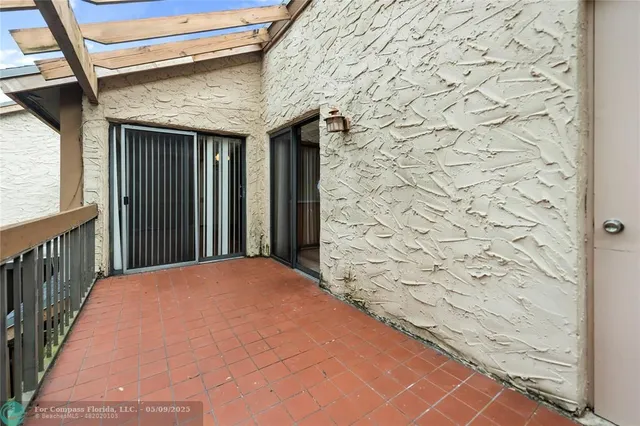 a balcony view with a brick wall