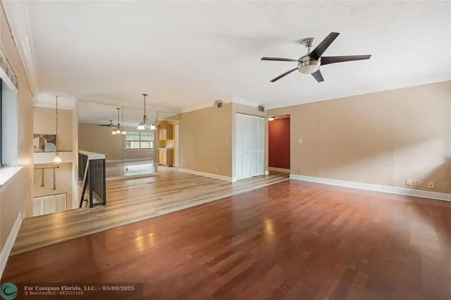 a view of a living room and kitchen with a sink