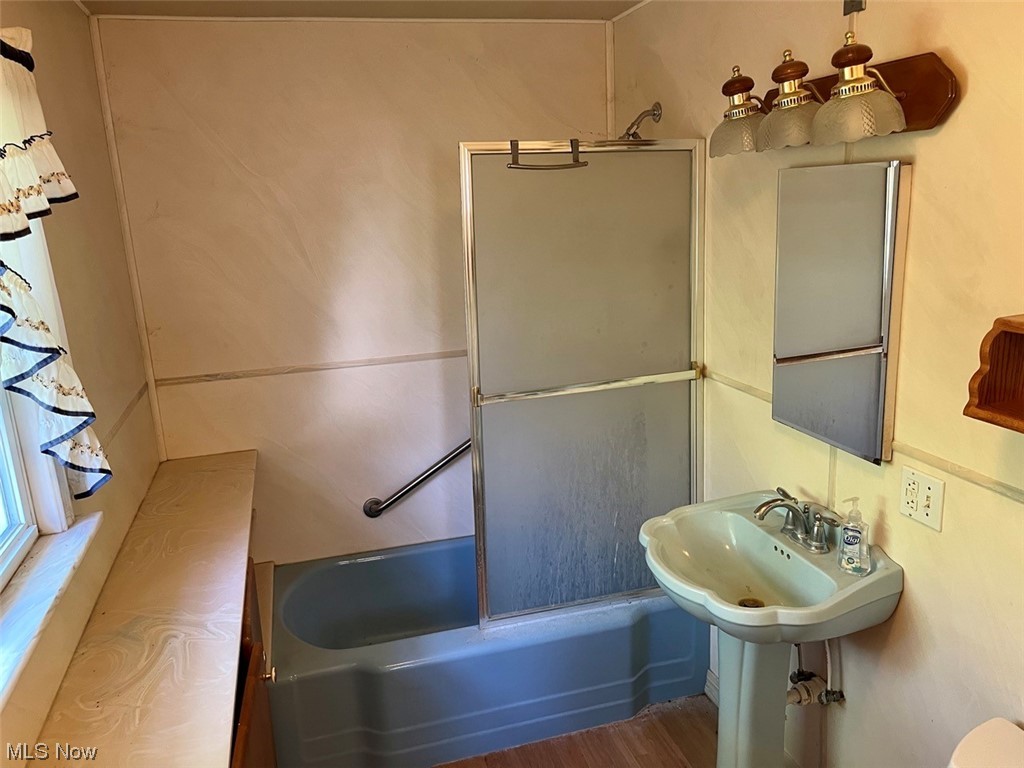 16485 Mock Road Berlin Center, OH 44401 - Photo 26 of 30 Bathroom with sink, hardwood flooring, and enclosed tub / shower combo