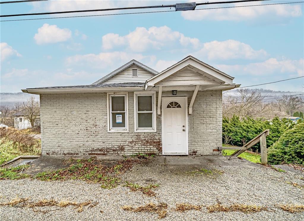 a view of a brick house with large windows