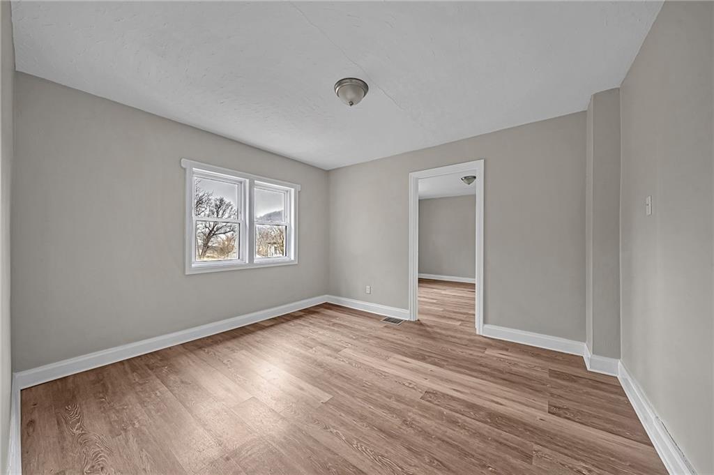 980 Crucible Road Rices Landing, PA 15357 - Photo 11 of 24 a view of an empty room with wooden floor and a window