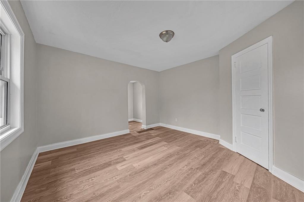 980 Crucible Road Rices Landing, PA 15357 - Photo 15 of 24 a view of an empty room with wooden floor and a window