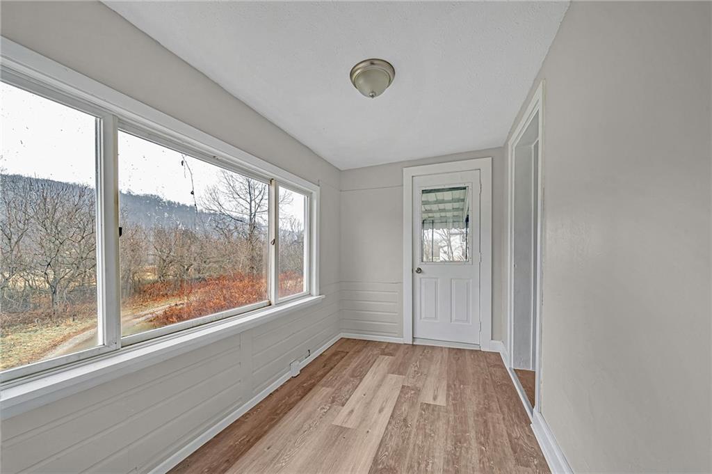 980 Crucible Road Rices Landing, PA 15357 - Photo 17 of 24 a view of empty room with wooden floor and fan