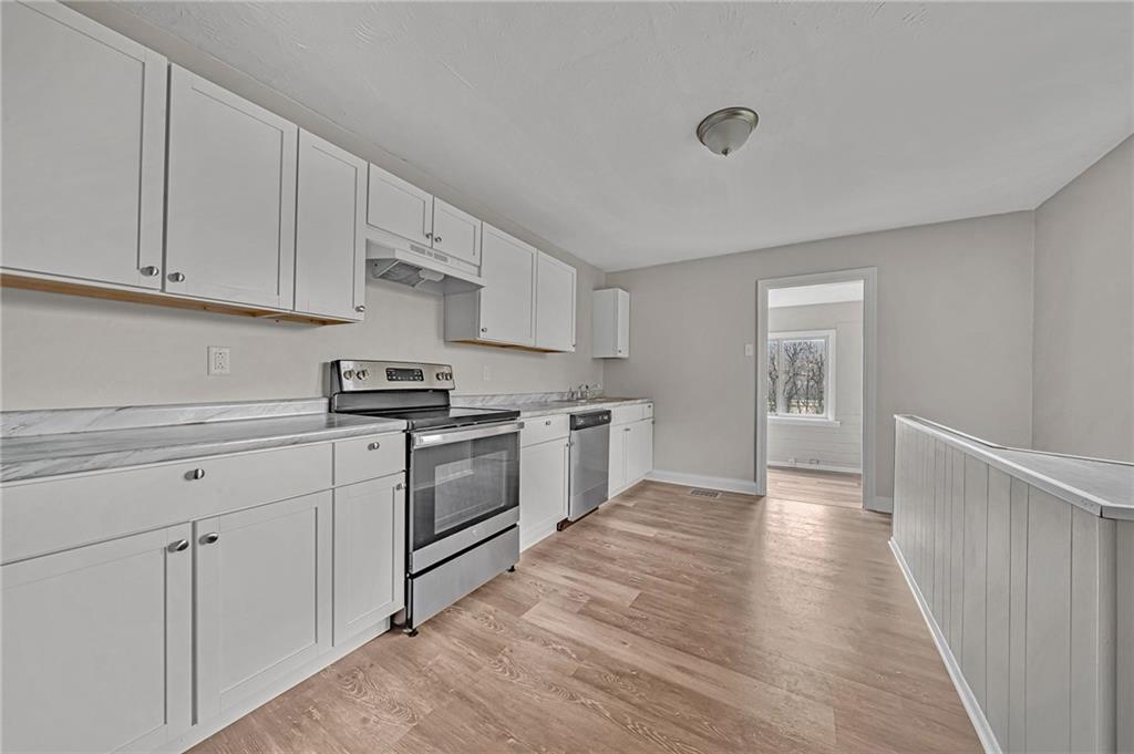 980 Crucible Road Rices Landing, PA 15357 - Photo 19 of 24 a kitchen with white cabinets and white appliances